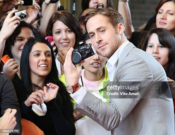Actor Ryan Gosling poses with fans at the "Blue Valentine" Premiere during the 35th Toronto International Film Festival at Ryerson Theatre on...
