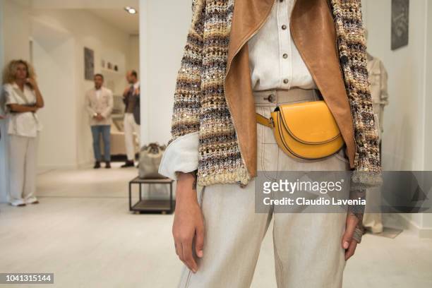 Model, bag detail, is seen at the Brunello Cucinelli presentation during Milan Fashion Week Spring/Summer 2019 on September 19, 2018 in Milan, Italy.