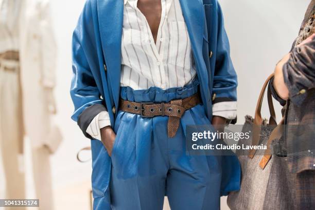 Model, belt detail, is seen at the Brunello Cucinelli presentation during Milan Fashion Week Spring/Summer 2019 on September 19, 2018 in Milan, Italy.