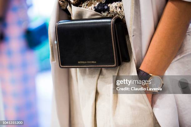 Model, bag detail, is seen at the Brunello Cucinelli presentation during Milan Fashion Week Spring/Summer 2019 on September 19, 2018 in Milan, Italy.