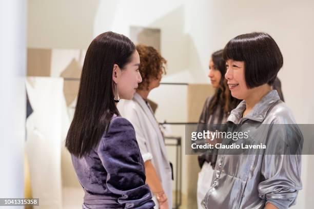 Dong Jie and Angelica Cheung are seen at the Brunello Cucinelli presentation during Milan Fashion Week Spring/Summer 2019 on September 19, 2018 in...