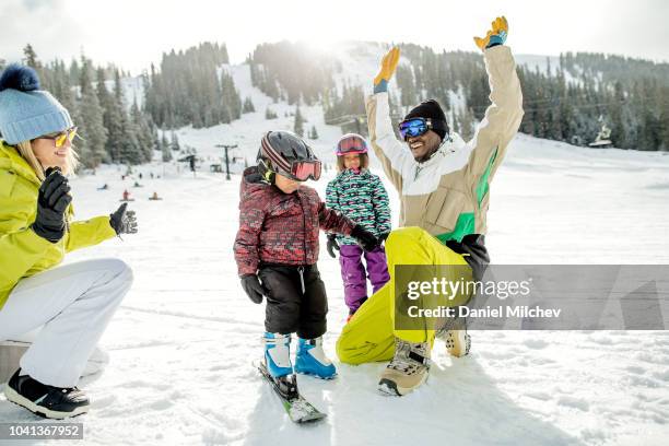 family having fun during the winter at a ski resort on a nice day. - family skiing bildbanksfoton och bilder