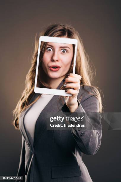 girl holding tablet with a selfie - excited face selfie stock pictures, royalty-free photos & images