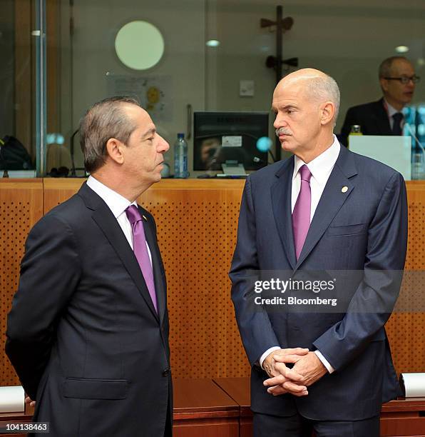 Lawrence Gonzi, Malta's prime minister, left, speaks with George Papandreou, Greece's prime minister, during the European Union summit meeting at the...