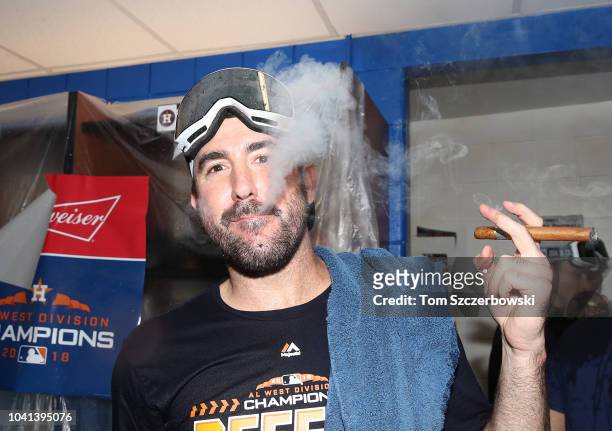 Justin Verlander of the Houston Astros celebrates in the clubhouse after the Astros clinched the American League West division title after their MLB...