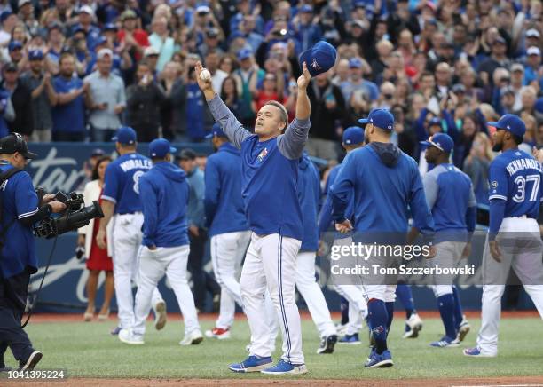 Manager John Gibbons of the Toronto Blue Jays salutes the fans after their victory and his final home game as manager after their MLB game against...