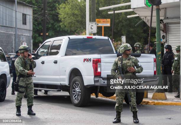 Mexican Army and state Police members guard the place where four men died after a shooting with state police, in Monterrey, Mexico on September 26,...