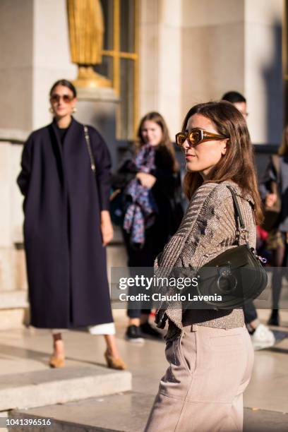 Julia Haghjoo and Sylvia Haghjoo, wearing a blue coat, white trousers, blue Chanel bag and tan shoes , and taupe sweater, taupe trousers and black...