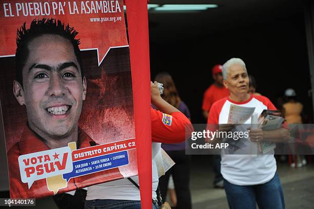 Backers of the government of Venezuelan President Hugo Chavez distribute electoral propaganda during a campaign rally of Robert Serra, candidate to...