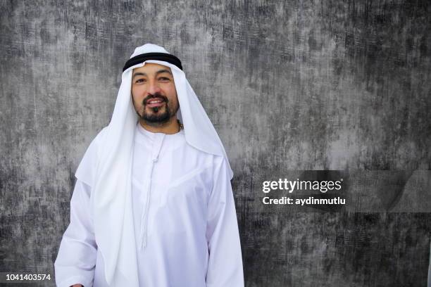 arab businessman standing in office - west asian people stock pictures, royalty-free photos & images