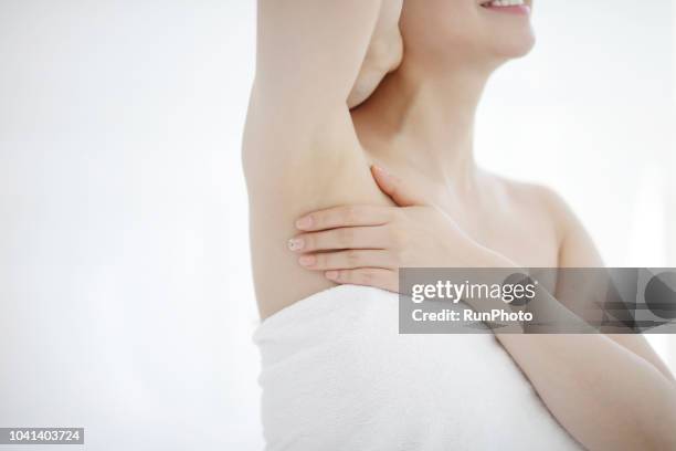 cropped image of woman touching armpit - deodorant stock-fotos und bilder