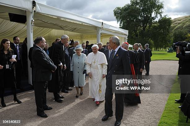 Queen Elizabeth II and Pope Benedict XVI walk through the gardens at the Palace of Holyroodhouse during day one of his four day state visit to the...