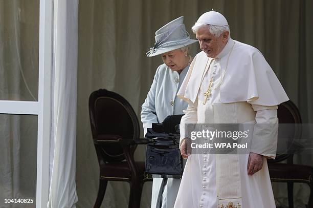 Queen Elizabeth II and Pope Benedict XVI walk through the gardens at the Palace of Holyroodhouse during day one of his four day state visit to the...