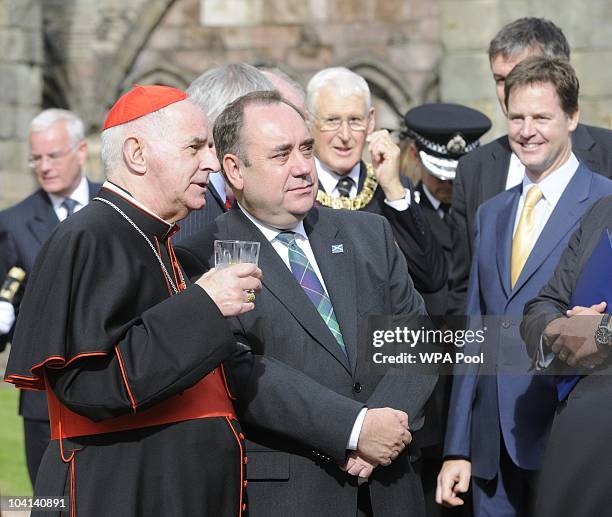 Cardinal Keith O'brien with Scottish First Minister Alex Salmond and Nick Clegg in background in through the gardens at the Palace of Holyroodhouse...