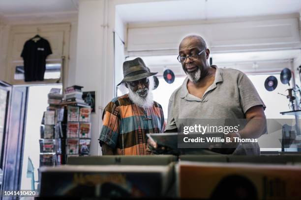 elderly black friends searching record bin - record store stock pictures, royalty-free photos & images