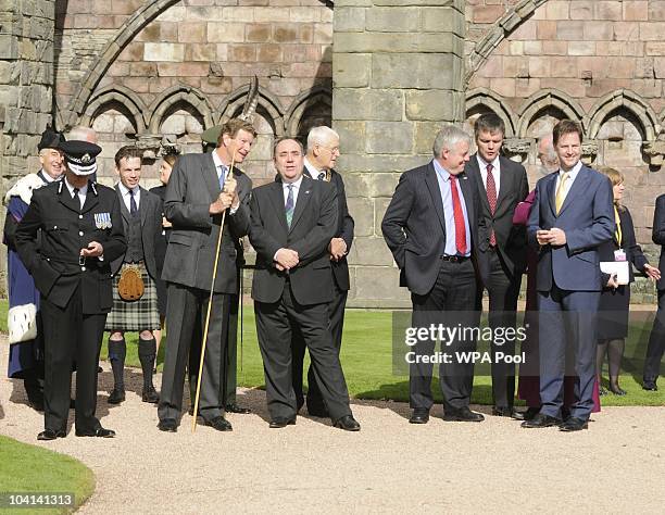 Guests with Scottish First Minister Alex Salmond and Deputy PM Nick Clegg wait in the gardens at the Palace of Holyroodhouse during day one of his...