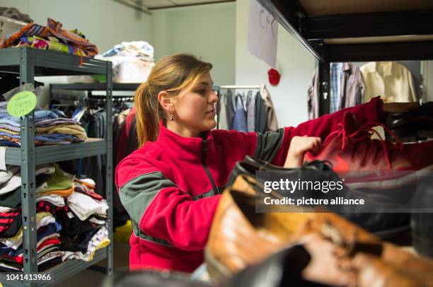 Social worker Fanny Koehler sorts donated shoes at the refugee shelter in Borbecker Strasse in Duesseldorf, Germany, 22 October 2015. Photo: Monika...