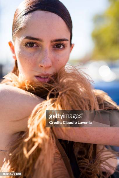Model Teddy Quinlivan, wearing a deconstructed tan jacket and black boots, is seen after the Maison Margiela show on September 26, 2018 in Paris,...