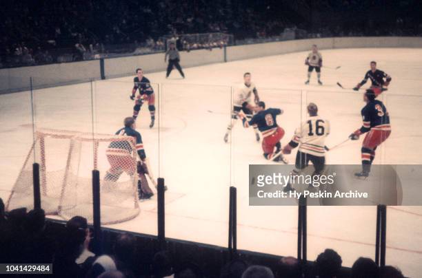 Goalie Gump Worsley, Lou Fontinato, Harry Howell of the New York Rangers and Bobby Hull of the Chicago Blackhawks look up for the puck during an NHL...
