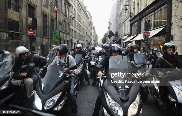 Press photographers are seen on scooters following Kim Kardashian during a shopping session on September 16, 2010 in Paris, France.