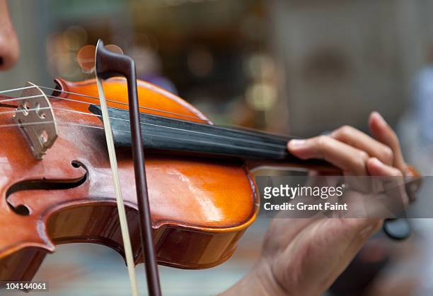 detail view man playing violin in public - violin ストックフォトと画像