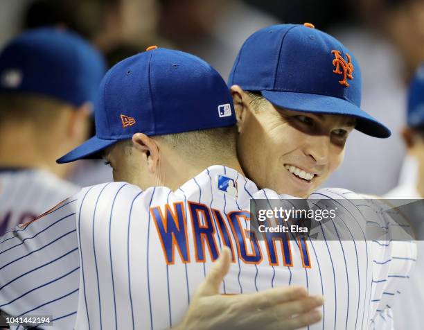 Jacob deGrom of the New York Mets is congratulated by teammate David Wright as deGrom walked into the dugout after the final out of the eighth inning...