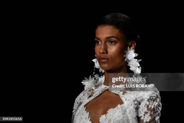 Model presents a creation by Spanish designer Rosa Clara during the Cali Exposhow Fashion Week on September 26 at the Military School of Aviation...