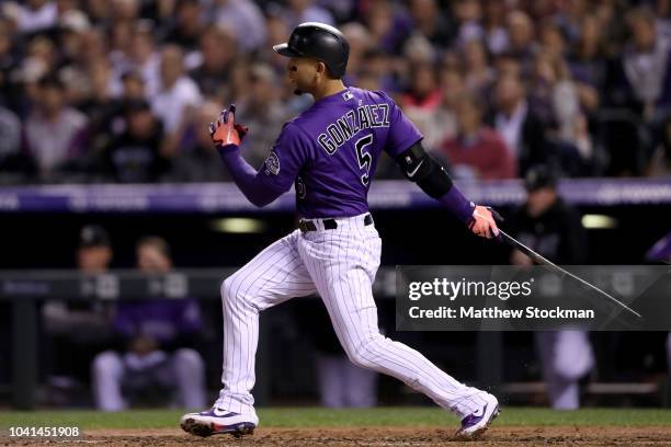 Carlos Gonzalez of the Colorado Rockies hits a RBI single in the fourth inning against the Philadelphia Phillies at Coors Field on September 26, 2018...