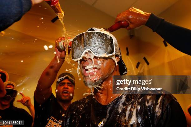 Keon Broxton of the Milwaukee Brewers celebrates with his teammates after clinching a post-season birth at Busch Stadium on September 26, 2018 in St....