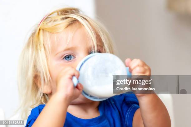 child having her milk - drinking milk stock pictures, royalty-free photos & images