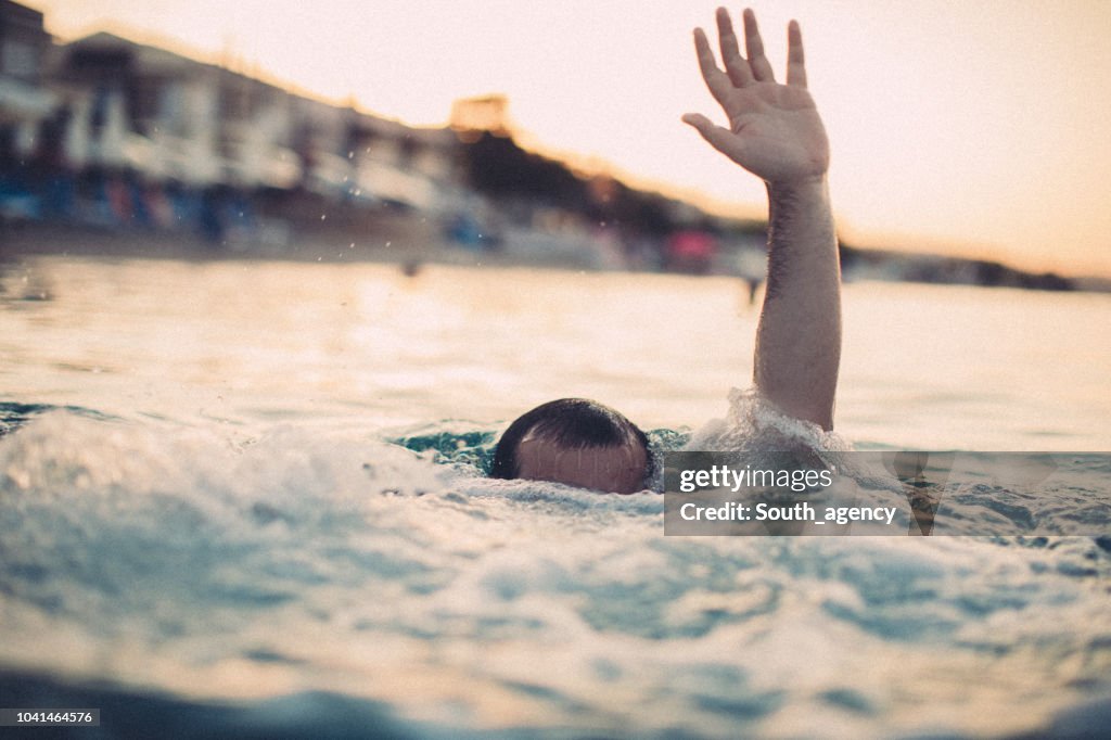 Young man drowning in the water