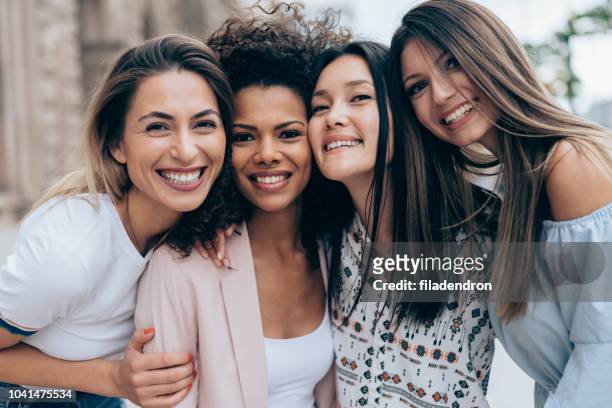 portrait of four best girlfriends - arm in arm stock pictures, royalty-free photos & images