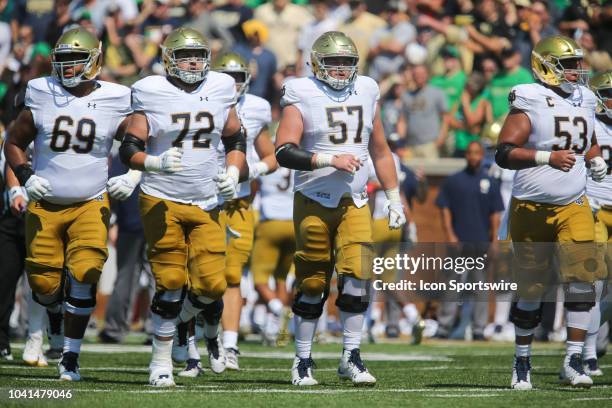 Notre Dame Fighting Irish offensive linemen Aaron Banks , Robert Hainsey , Trevor Ruhland , and Sam Mustipher prepare for the next play against the...