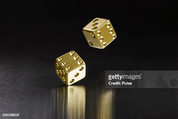 bouncing gold dice. - dice pair stock-fotos und bilder