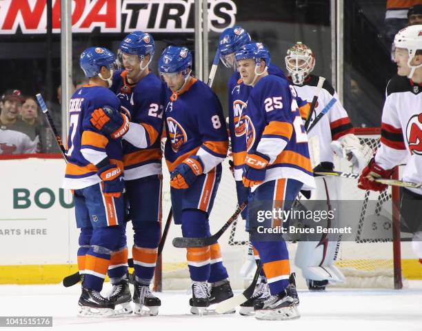 Jordan Eberle, Anders Lee, Steve Bernier and Devon Toews of the New York Islanders celebrate Lee's third period goal against the New Jersey Devils...