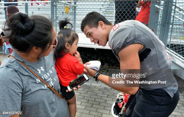 St. John's quarterback Sol-Jay Maiava talks with Anizhe and her mother Roslyn Lefau after the game against Marietta High School on September 22, 2018...