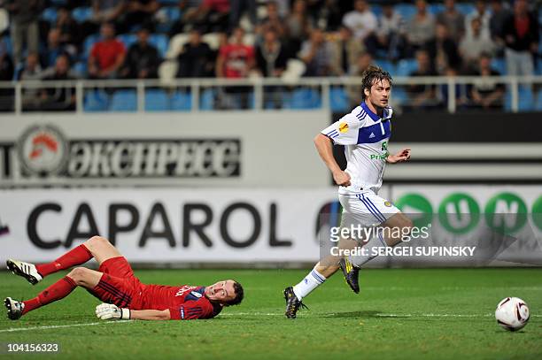 Dynamo Kiev's Artem Milevskiy runs to score after avoiding a tackle from FC Bate's goalkeeper Sergei Veremko during their UEFA Europa League...