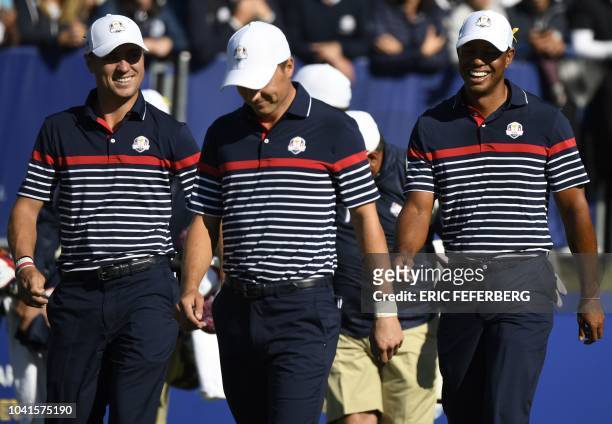 Golfer Tiger Woods walks with teammates US golfer Jordan Spieth and US golfer Justin Thomas during a practice session ahead of the 42nd Ryder Cup at...