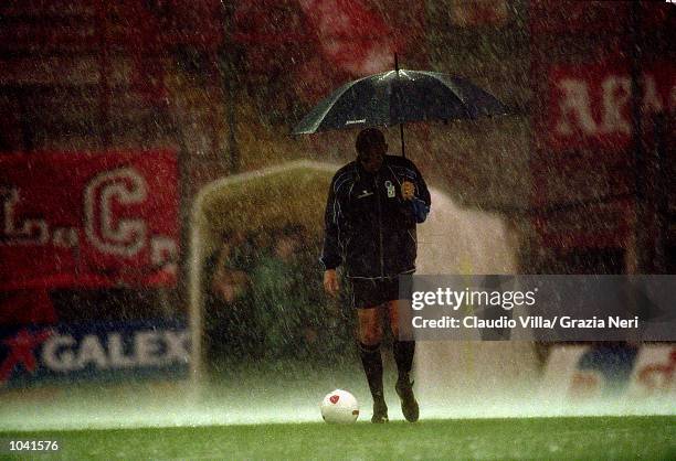 Referee Pierluigi Collina tests waterlogged pitch during the Italian Serie A match between Perugia and Juventus at the Stadio Curi A, in Perugia,...