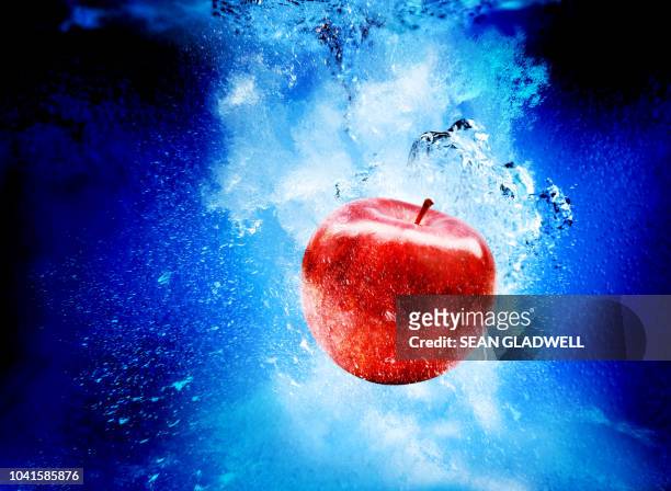 red apple in water - juicy stock pictures, royalty-free photos & images