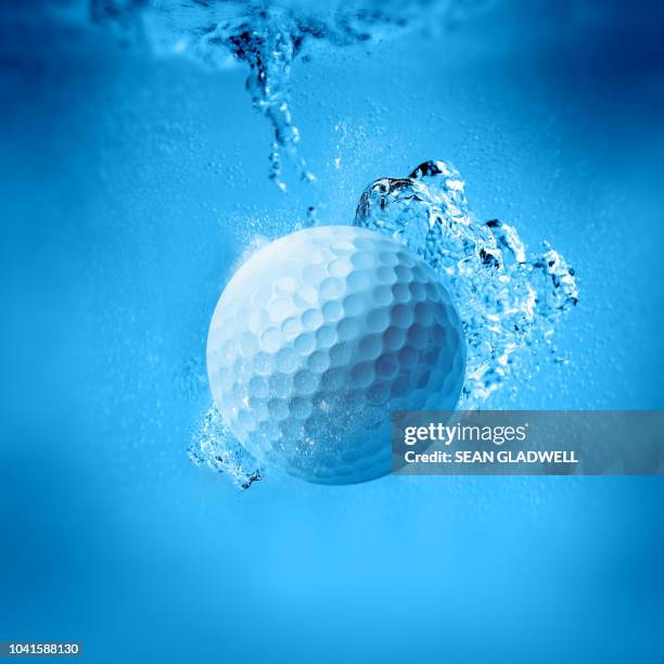 golf ball splash - golf ball water stock pictures, royalty-free photos & images