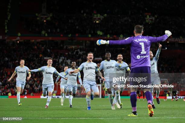 Derby players celebrate with Derby goalkeeper Scott Carson after his penalty save gifted them victory during the Carabao Cup Third Round match...