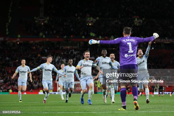 Derby players celebrate with Derby goalkeeper Scott Carson after his penalty save gifted them victory during the Carabao Cup Third Round match...