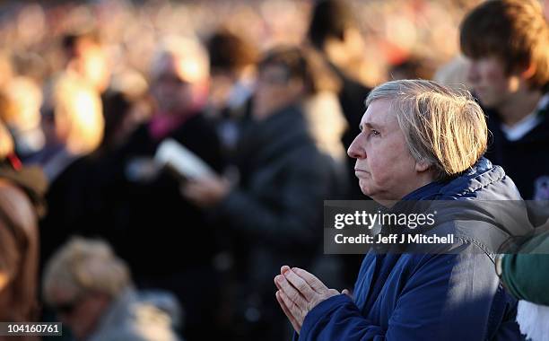 Woman attends the Papal Mass at Bellahouston Park on September 16, 2010 in Glasgow, Scotland. Pope Benedict XVI is conducting the first state visit...