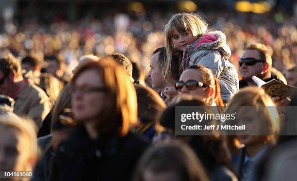 Young girl attends the Papal Mass at Bellahouston Park on September 16, 2010 in Glasgow, Scotland. Pope Benedict XVI is conducting the first state...