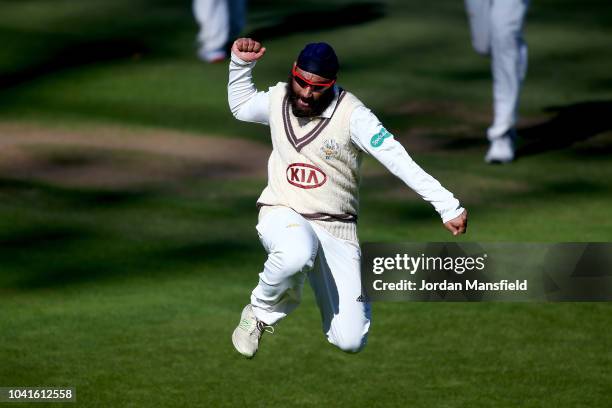 Amar Viridi of Surrey celebrates dismissing Ravi Bopara of Essex during day three of the Specsavers County Championship Division One match between...
