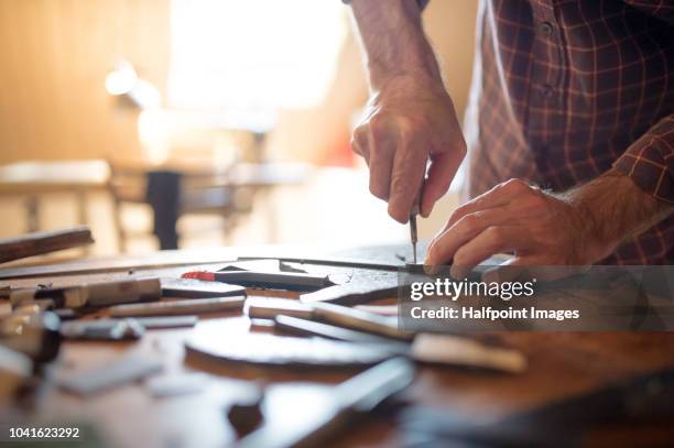 a small business of a craftsman making leather and canvas bags. - leather industry stock pictures, royalty-free photos & images