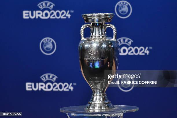 Picture taken on September 27, 2018 shows the UEFA Euro trophy on display few moments before the announcement of the elected country which will host...