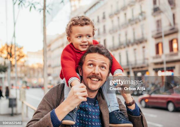 father with his kids walking on the street - winter barcelona stock pictures, royalty-free photos & images