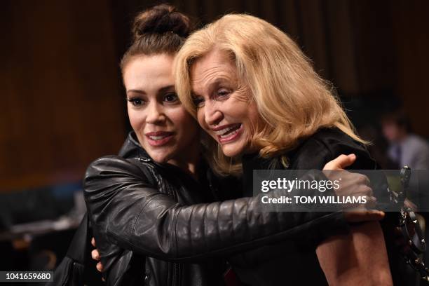 Actress Alyssa Milano hugs US Representative Carolyn Maloney in the hearing room before the start of Dr. Christine Blasey Ford's appearance in the...